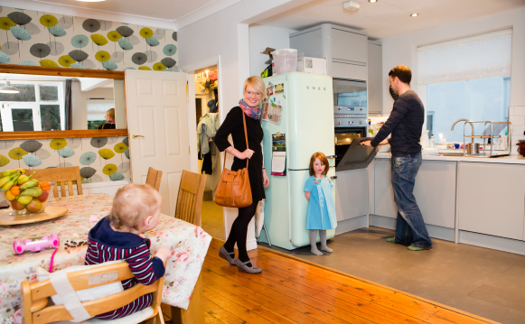 A domestic scene showing happy children with their mother and father