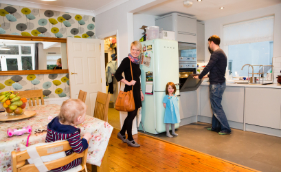 A domestic scene showing happy children with their mother and father