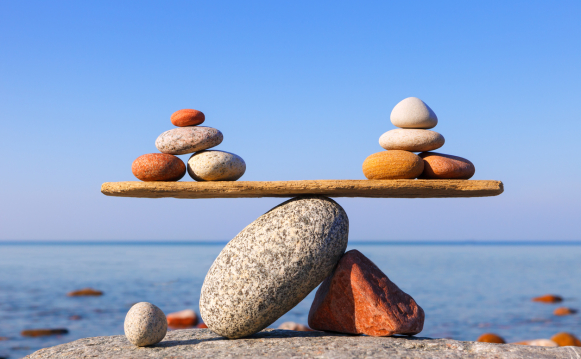 Beach pebbles symmetrically balancing on each other at the seaside
