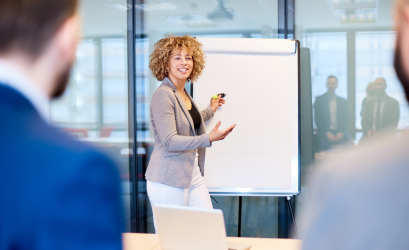 A woman standing in front of a board during a training session