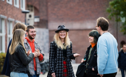 young people in a circle discussing and smiling