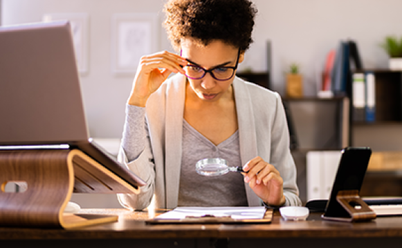 Picture of a woman reading a paper