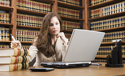 Picture of a woman with books and a laptop