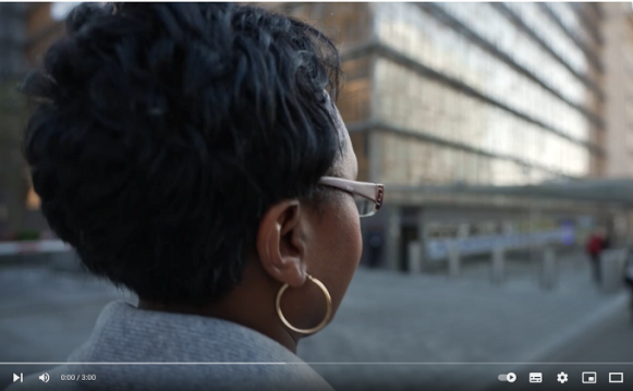 a woman in front of an institutional building