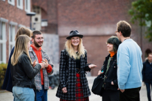 young people in a circle discussing and smiling